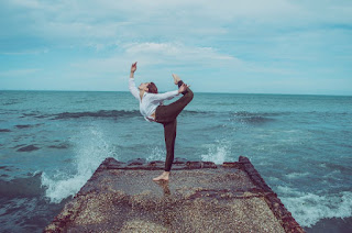 A woman having a meditative moment surrounded by ocean waves