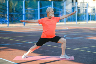 A man stretching his legs on the tennis court