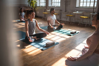 A group of people in a yoga class practicing meditation and pranayama, focusing on inner peace and balance.
