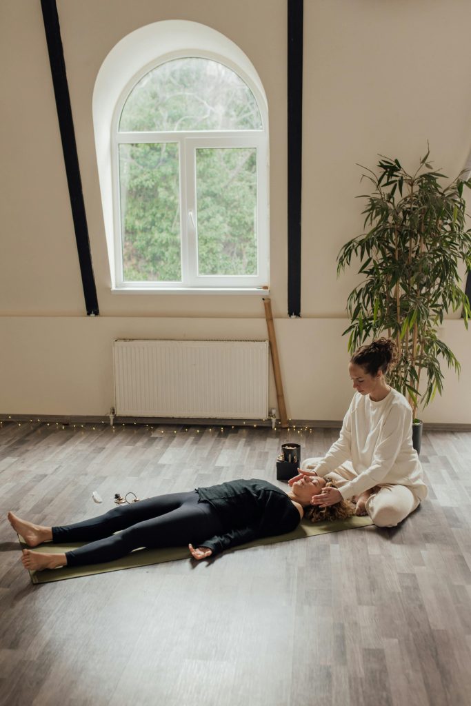 Individual practicing body-centered meditation lying down