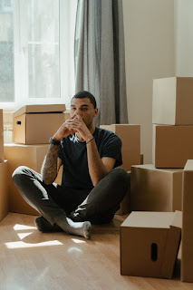 Creative use of a moving box as a meditation stool, illustrating adaptability and finding calm in chaos
