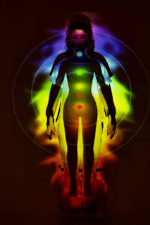 Individual meditating on balancing the body's chakras.