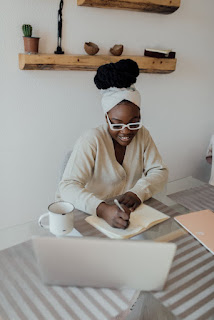 A woman documenting her recent experience at a group meditation, while at her local coffee shop.
