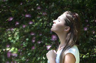 A woman is meditating to help herself through a difficult period of time in her life. Practicing loving and kindness to all living beings and herself to grow compassion and healing energy.