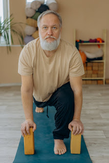 A man using yoga blocks to assist in a challenging pose