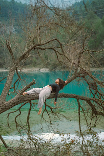 An image of a calm lake or body of water with a clear reflection of the sky or surrounding nature. Water is often used as a metaphor for a clear, undisturbed mind in meditation.