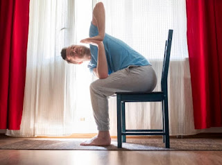 Seated forward bend pose in adaptive chair yoga