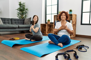 Women practicing yoga on mats indoors