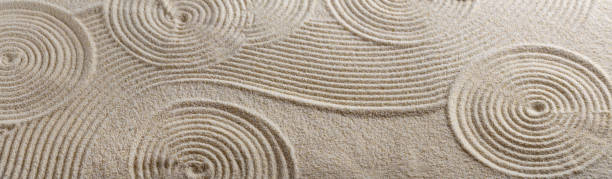A close-up view of intricate sand patterns in a Zen garden, symbolizing balance, mindfulness, and meditative calm.
