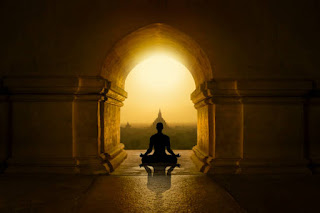 Gateway to Inner Peace Alt Text: A meditating figure silhouetted against the backdrop of a temple archway at sunrise, symbolizing spiritual exploration and the deeper states of meditation.