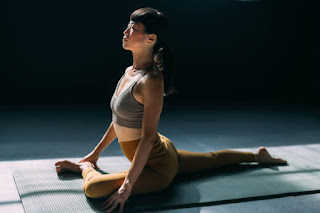 Woman practicing Pigeon Pose on a yoga mat