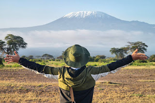 Young adult practicing breathwork or pranayama, hands on chest and abdomen, peaceful expression, indoor or outdoor setting, relaxing atmosphere.