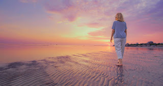 Person walking forward at sunset, symbolizing the ongoing journey of change and growth.