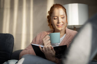 Open journal with a pen and warm beverage, representing reflective journaling on rest days.