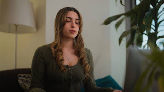Person meditating with closed eyes, symbolizing visualization, focus, and breaking through mental plateaus.