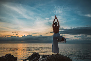 Person practicing Tree Pose in nature, focusing on balance and mental clarity.
