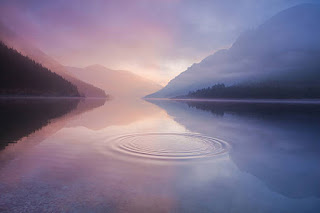 Tranquil sunrise over a calm lake, symbolizing a fresh start and peaceful mindset.