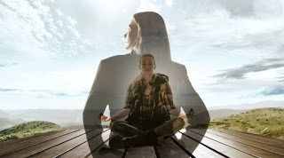 A person sitting cross-legged in meditation on a yoga mat, surrounded by a lush green forest, focusing on breath and visualization techniques.