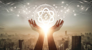 Hands cupping a glowing energy symbol over a Los Angeles, with swirling light patterns representing collective consciousness and vibrational energy.