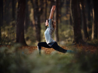 Yogi in warrior II pose for Kapha balancing yoga flow.
