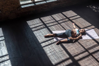 Yogi in boat pose counteracting Kapha heaviness in spring.