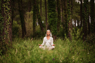 Yogi meditating with mantra in forest for inner peace.