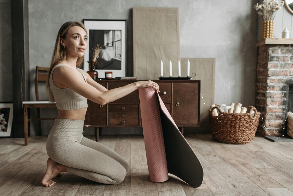 Yoga mat, candle, and journal arranged for a short mindful routine.