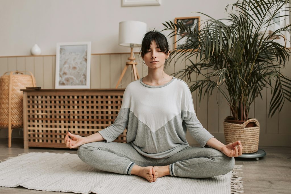 Woman meditating calmly to build self-awareness and self-regulation.