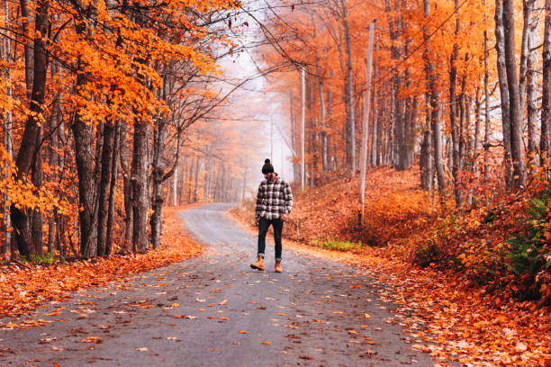 Person walking on a leaf-covered path to refresh mind and body for an End-of-Summer Reset