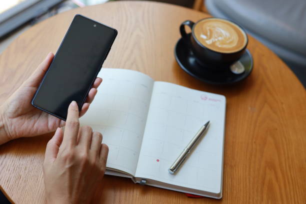 Phone face-down, planner with white space, coffee cooling untouched